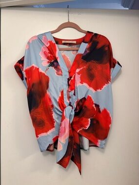 Hutch Ricci top featuring a floral print, tie front, and V-neckline. Ptp 23